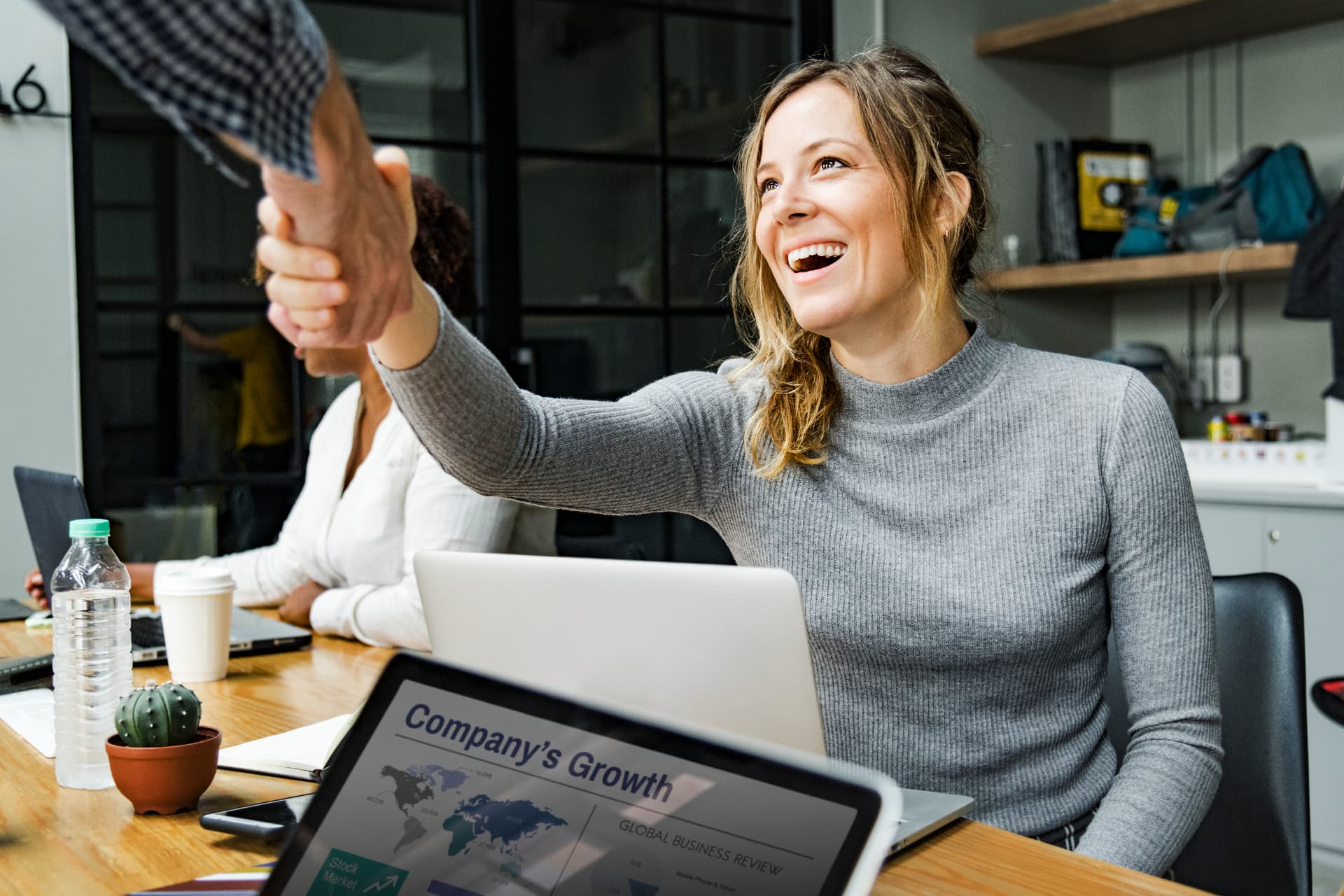Equipe de agência de marketing reunida e comemorando o fechamento de um contrato B2B de alto valor