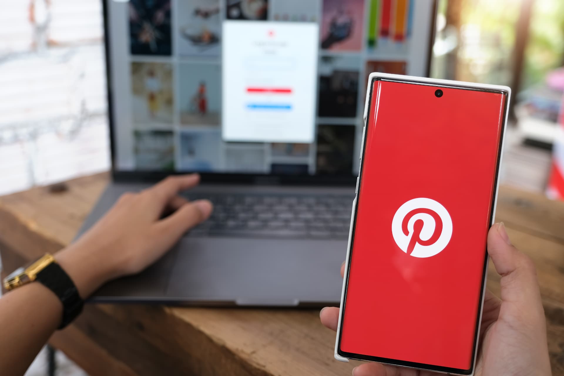 Smartphone exibindo o Pinterest diante de um notebook, ilustrando o planejamento visual com inteligência artificial